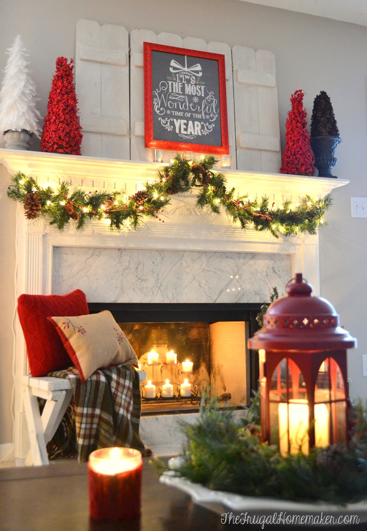 red, white and greenery on Christmas mantel