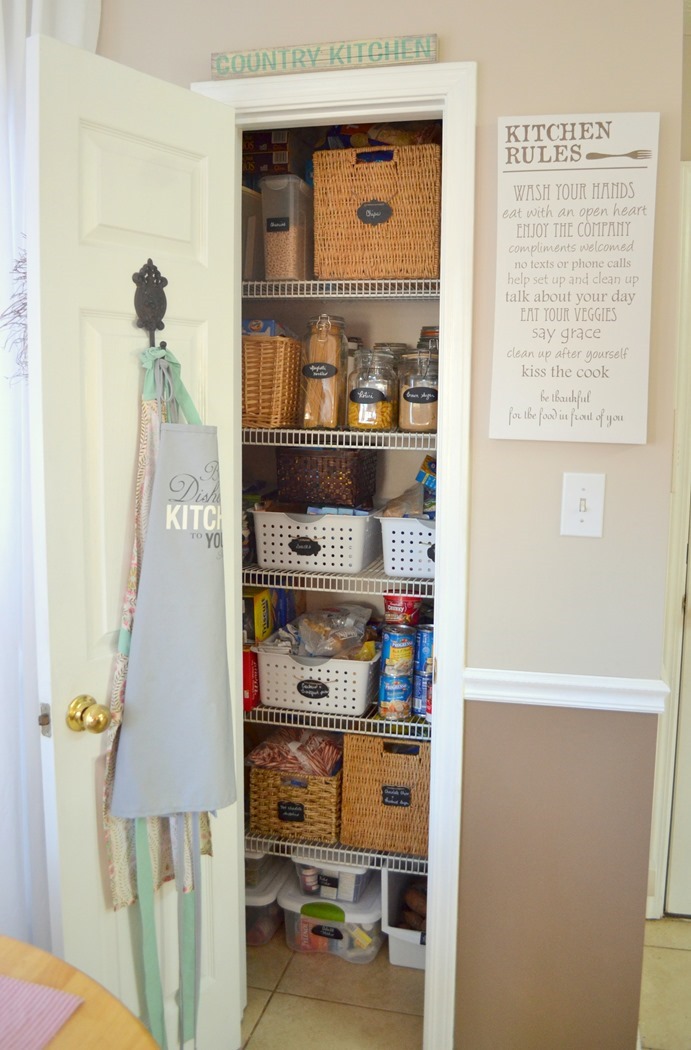 organized pantry with thrifted baskets and jars and chalkboard labels