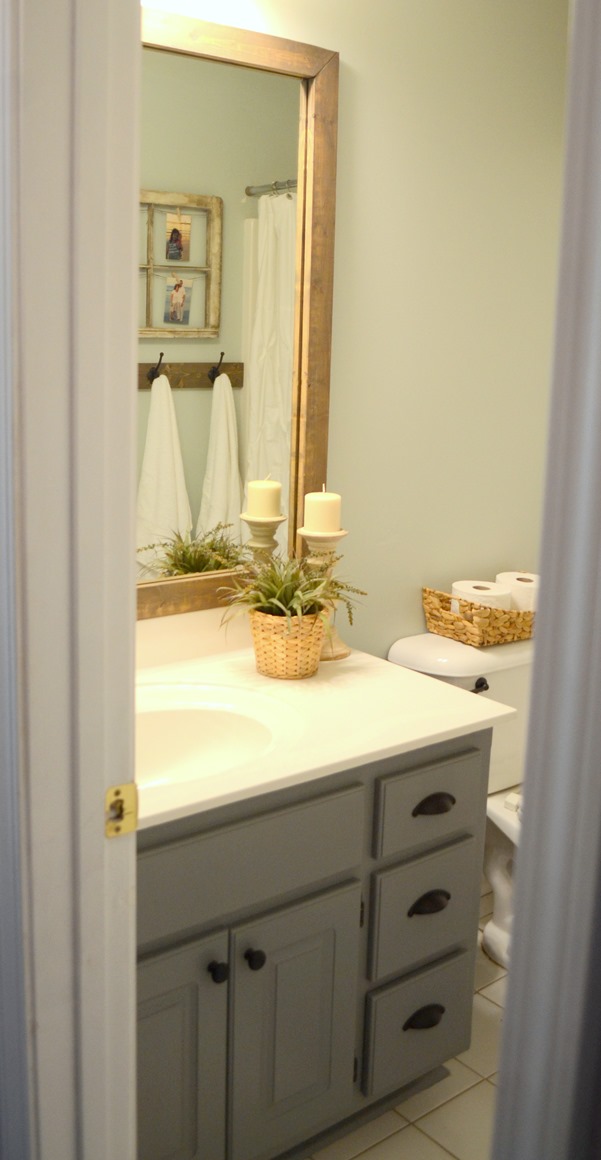 Stained wood framed bathroom mirror